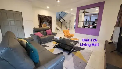 a living room with a couch and a table at Ipoh Family Villa-Spacious Stay for 21 or 42Pax in Ipoh