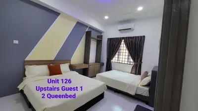 a small bedroom with two beds and a window at Ipoh Family Villa-Spacious Stay for 21 or 42Pax in Ipoh