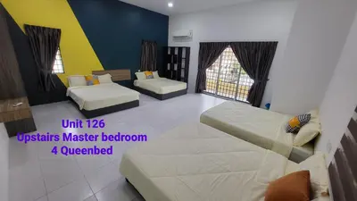 a living room with two beds and a couch at Ipoh Family Villa-Spacious Stay for 21 or 42Pax in Ipoh