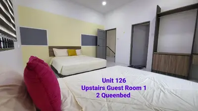 a bedroom with two beds in a room at Ipoh Family Villa-Spacious Stay for 21 or 42Pax in Ipoh