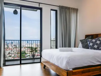 a bedroom with a bed and a large window at Beacon Executive Suites by S&F #InfinityPool #SkyGym in George Town