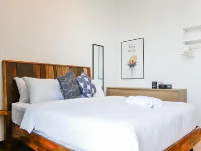 a bedroom with a large bed with white sheets and pillows at Beacon Executive Suites by S&F #InfinityPool #SkyGym in George Town