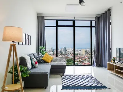 a living room with a couch and a large window at Beacon Executive Suites by S&F #InfinityPool #SkyGym in George Town
