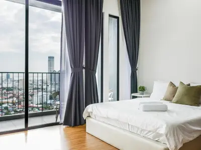 a bedroom with a white bed and large windows at Beacon Executive Suites by S&F #InfinityPool #SkyGym in George Town