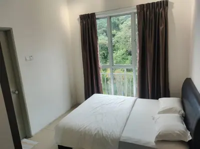 a bedroom with a bed and a large window at Salena Somersquare Goldenhills Tanah Rata(Pasar Malam) in Brinchang