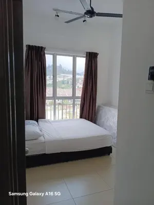 a bed in a room with a large window at Salena Somersquare Goldenhills Tanah Rata(Pasar Malam) in Brinchang