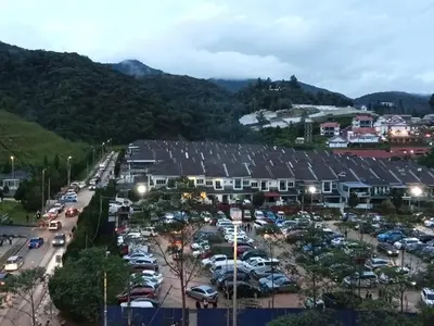 an aerial view of a parking lot with cars at Salena Somersquare Goldenhills Tanah Rata(Pasar Malam) in Brinchang