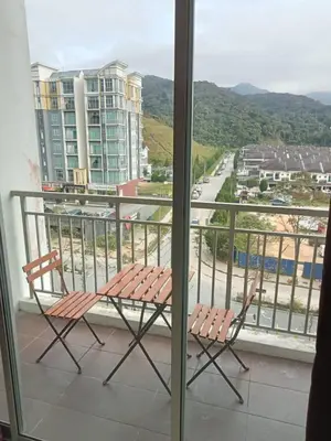 a balcony with two chairs and a view of a city at Salena Somersquare Goldenhills Tanah Rata(Pasar Malam) in Brinchang