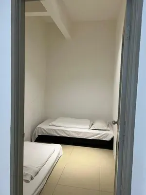 a room with two beds in a white room at Salena Somersquare Goldenhills Tanah Rata(Pasar Malam) in Brinchang
