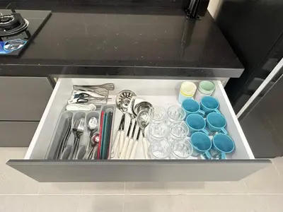 a drawer filled with utensils and drinking glasses at \u300aUntitled HomeStay\u300bSitiawan in Sitiawan