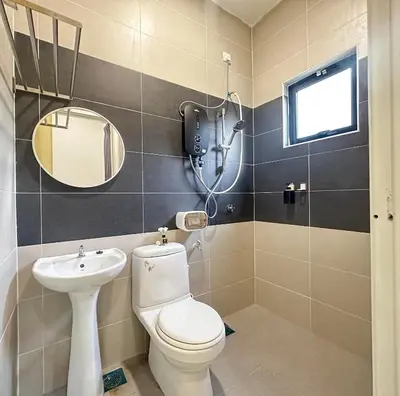 a bathroom with a toilet and a sink and a mirror at \u300aUntitled HomeStay\u300bSitiawan in Sitiawan