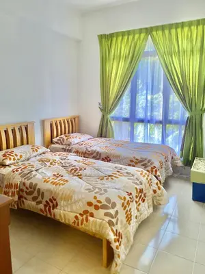 two beds in a room with a window at Homestay Legacy Kamariah Ahmad,Lumut in Lumut