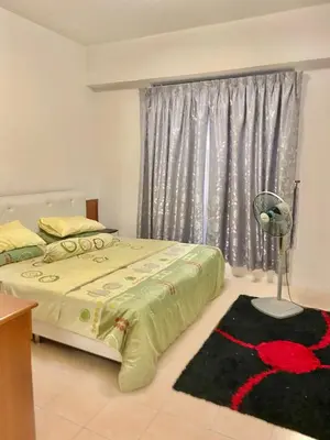 a bedroom with two beds and a fan and a window at Homestay Legacy Kamariah Ahmad,Lumut in Lumut