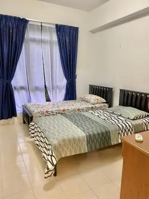 two beds in a room with blue curtains at Homestay Legacy Kamariah Ahmad,Lumut in Lumut
