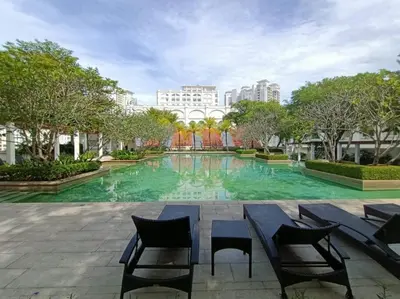 a large swimming pool with chairs and a table at Perfect Marina Stay@ Strait Quay /w Big Balcony + Carpark in Bagan Jermal