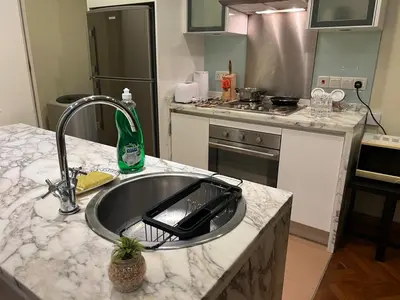 a kitchen with a sink and a counter top at Perfect Marina Stay@ Strait Quay /w Big Balcony + Carpark in Bagan Jermal