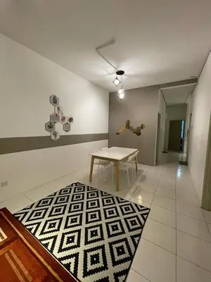 a room with a table and a person jumping in the air at Cameron Sweet Muslim Apartment 2 - Iiqoma Muslim Homestay in Tanah Rata