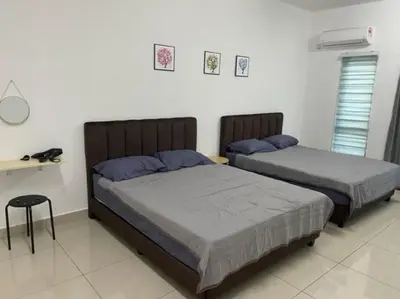 a bedroom with two beds and a table at KY Happiness Homestay Tanjong Karang \u5feb\u4e50\u6c11\u5bbf in Tanjung Karang