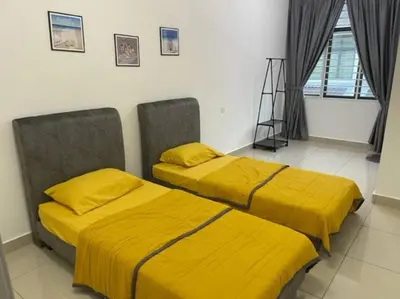 two beds with yellow covers in a room at KY Happiness Homestay Tanjong Karang \u5feb\u4e50\u6c11\u5bbf in Tanjung Karang