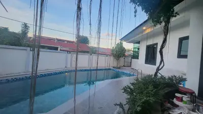 a swimming pool in the backyard of a house at Fairy Retreat Private Pool Cottage IPOH, BBQ, KTV, 10-12 pax in Ipoh