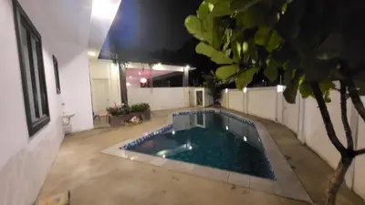 a swimming pool in the middle of a house at Fairy Retreat Private Pool Cottage IPOH, BBQ, KTV, 10-12 pax in Ipoh