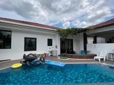 a swimming pool with an inflatable pool toy in a house at Fairy Retreat Private Pool Cottage IPOH, BBQ, KTV, 10-12 pax in Ipoh