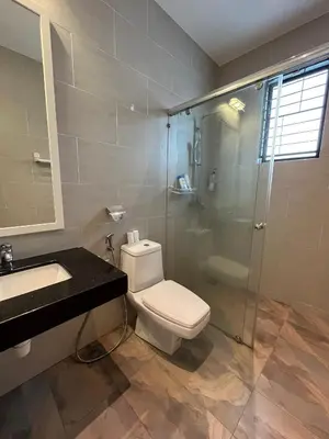 a bathroom with a toilet and a glass shower at Fairy Retreat Private Pool Cottage IPOH, BBQ, KTV, 10-12 pax in Ipoh