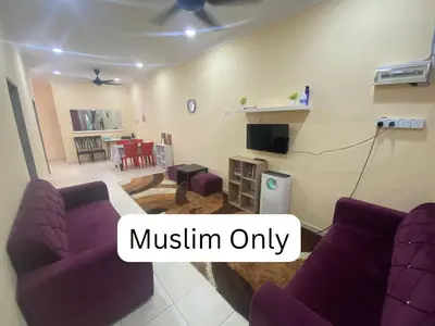 a living room with purple couches and a dining room at Homestay Cikgu Muaz in Kuala Kangsar