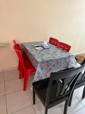 a dining room table with red chairs and a blue table cloth at Homestay Cikgu Muaz in Kuala Kangsar