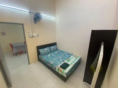 a small bed in a room with a mirror at Homestay Cikgu Muaz in Kuala Kangsar