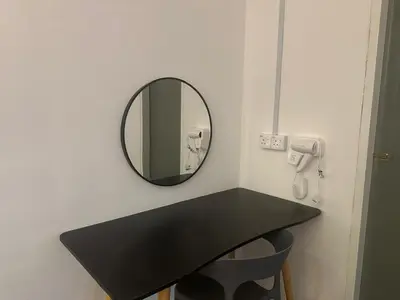 a bathroom with a black counter and a mirror at Jenny Homestay in Teluk Intan
