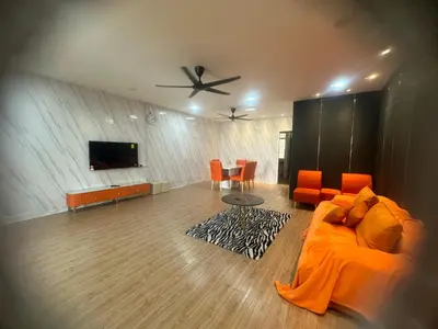 a living room with a couch and a flat screen tv at Jenny Homestay in Teluk Intan