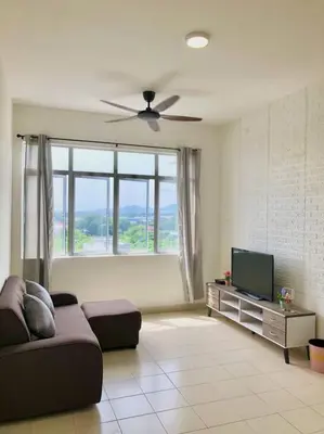 a living room with a couch and a flat screen tv at ECO Apartment (Ipoh Falim) -2B2B in Ipoh