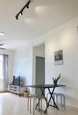 a table and chairs in a room with a tv at ECO Apartment (Ipoh Falim) -2B2B in Ipoh