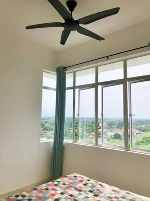 a bedroom with a ceiling fan and a large window at ECO Apartment (Ipoh Falim) -2B2B in Ipoh