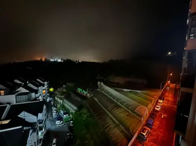a view of a city at night with buildings at stoberi cekelat homestay in Brinchang