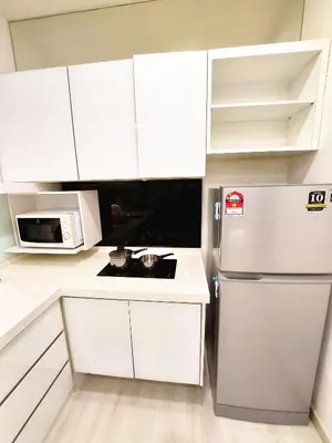 a kitchen with white cabinets and a refrigerator at SG10-4Pax 2rooms Studio Georgetown in George Town