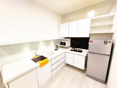 a white kitchen with a sink and a refrigerator at SG10-4Pax 2rooms Studio Georgetown in George Town