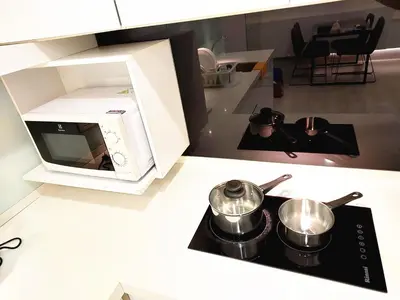 a kitchen with a microwave and two pots on a stove at SG10-4Pax 2rooms Studio Georgetown in George Town