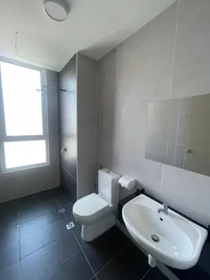 a bathroom with a white toilet and a sink at Spacious Family Staycation 3BR at Ipoh Uptown in Ipoh