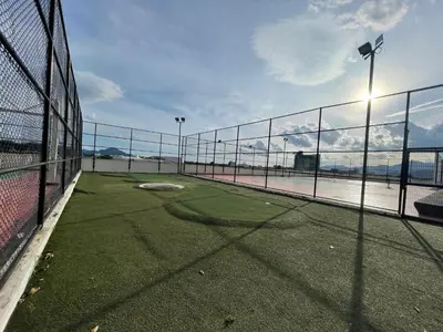 an empty tennis court with a fence and a tennis court at Spacious Family Staycation 3BR at Ipoh Uptown in Ipoh
