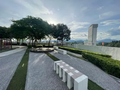 a park with a row of benches on a street at Spacious Family Staycation 3BR at Ipoh Uptown in Ipoh