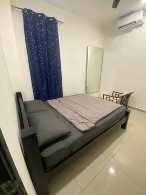 a bedroom with a bed and a blue curtain at A Home - Homestay near St Anne Church Bukit Mertajam in Bukit Mertajam