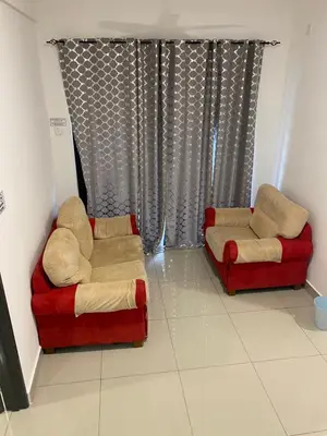 two chairs and a couch in a living room at A Home - Homestay near St Anne Church Bukit Mertajam in Bukit Mertajam