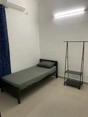 a bed and a chair in a room at A Home - Homestay near St Anne Church Bukit Mertajam in Bukit Mertajam