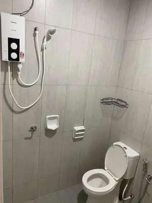 a shower stall with a toilet in a bathroom at A Home - Homestay near St Anne Church Bukit Mertajam in Bukit Mertajam