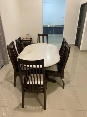 a dining room table with four chairs around it at A Home - Homestay near St Anne Church Bukit Mertajam in Bukit Mertajam
