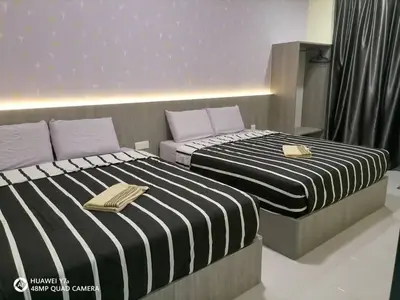 two beds sitting next to each other in a room at Stobericekelathomestay in Cameron Highlands