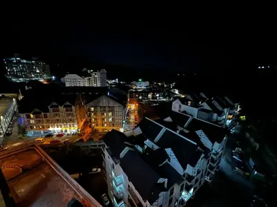 a view of a city at night with buildings at Stobericekelathomestay in Cameron Highlands