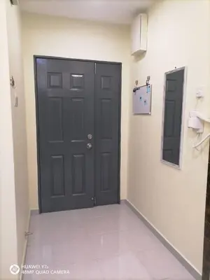 a black door in a room with a tile floor at Stobericekelathomestay in Cameron Highlands